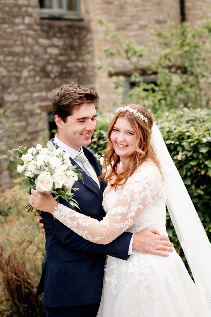 bride and groom hugging light airy romantic portrait