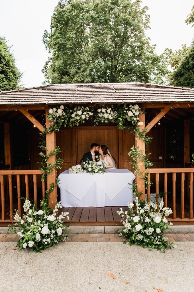 outdoor wedding ceremony at The Greenway Hotel captured by Cotswolds wedding photographer