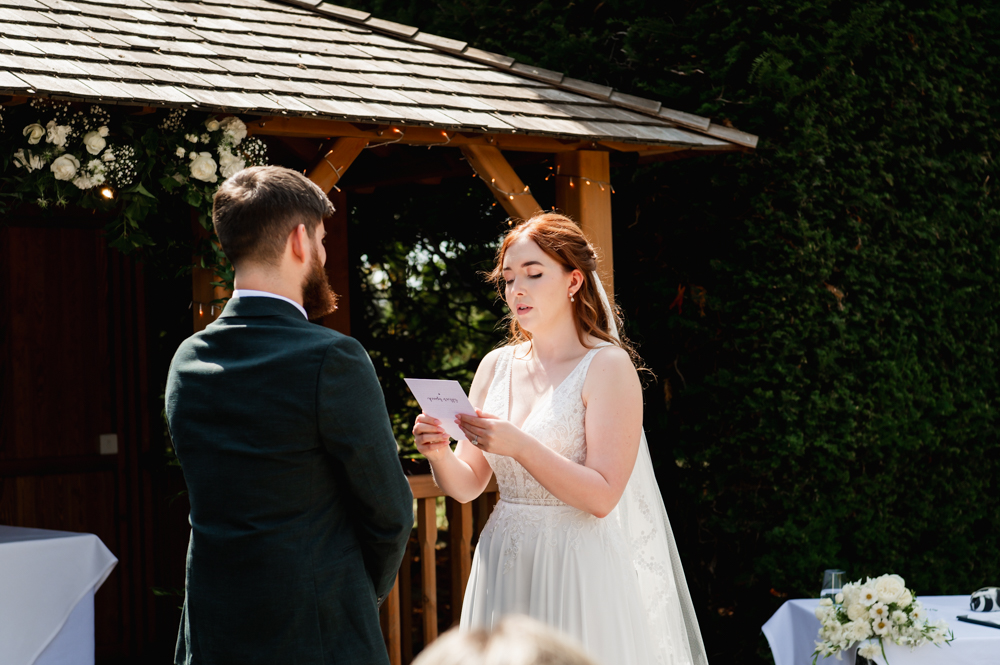 bride telling her vows during a wedding ceremony at The Greenway hotel