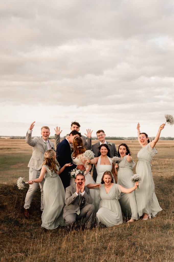 bride and groom with guests fun relaxed pose
