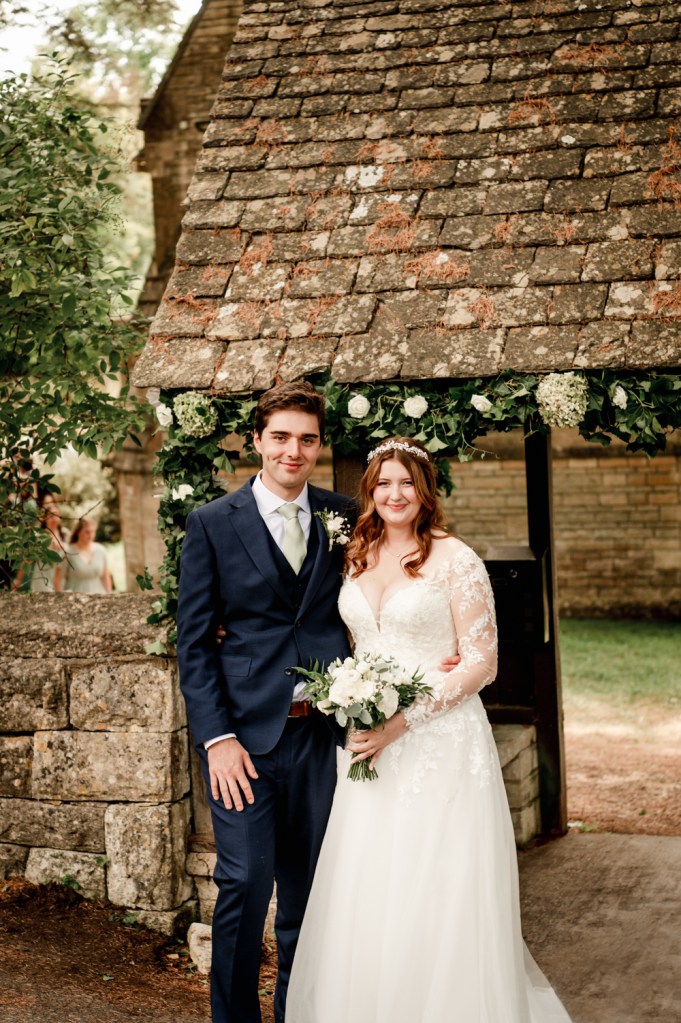 bride and groom under  church arch
