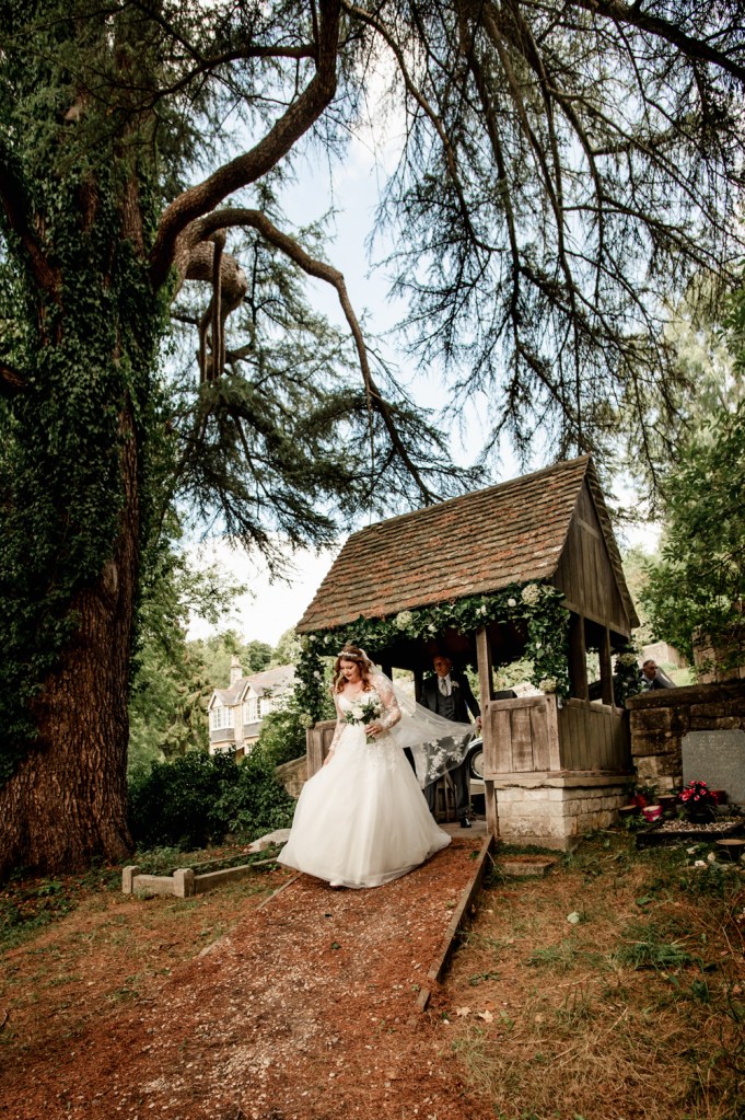 bride walking through church gates
